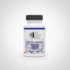 A bottle of Ortho-Ncicular Products Ortho-Biotic 100 Billion Cols supplement resting on a laptop keyboard in a home office setting.